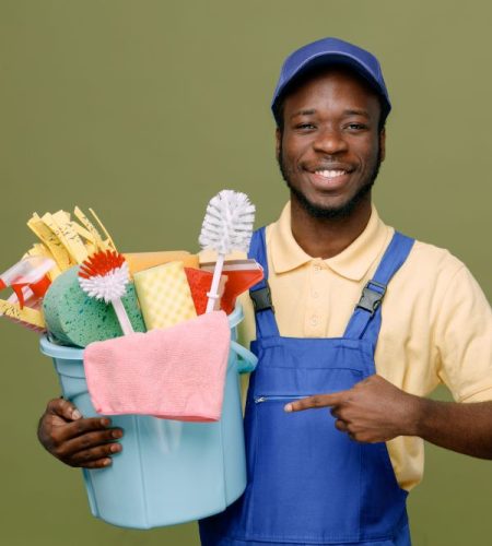 smiling-holding-points-bucket-cleaning-tools-young-africanamerican-cleaner-male-uniform-with-gloves-isolated-green-background format